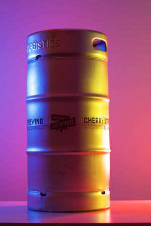 photo of cherry street brewing branded keg with yellow blue and red lights shining on it