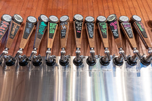 photo of tap wall with handles and variety of beers taproom cherry street brewing forsyth county georgia